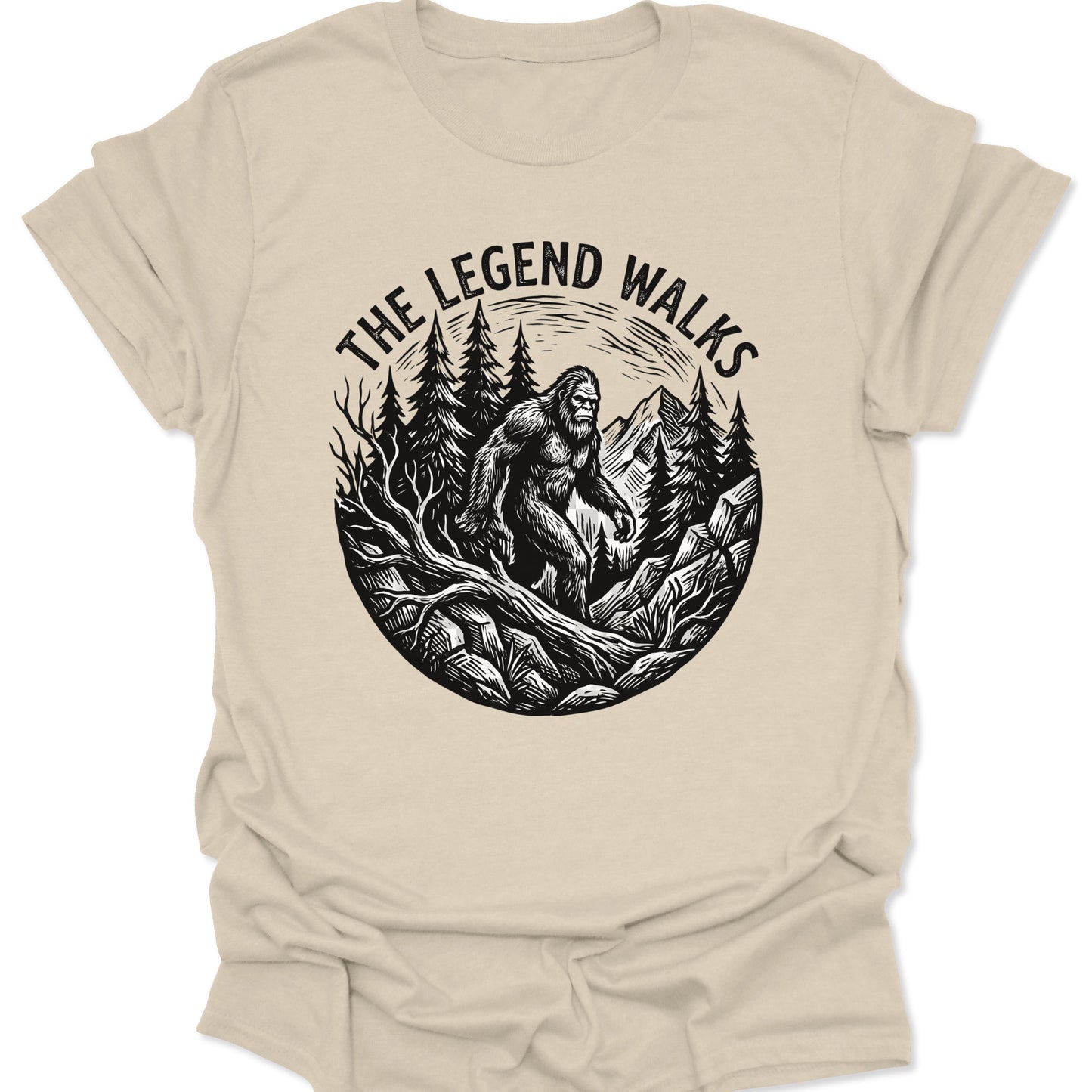 Natural unisex adult t-shirt featuring a hand-drawn legend walks cryptid design with tall evergreen trees and peaks.