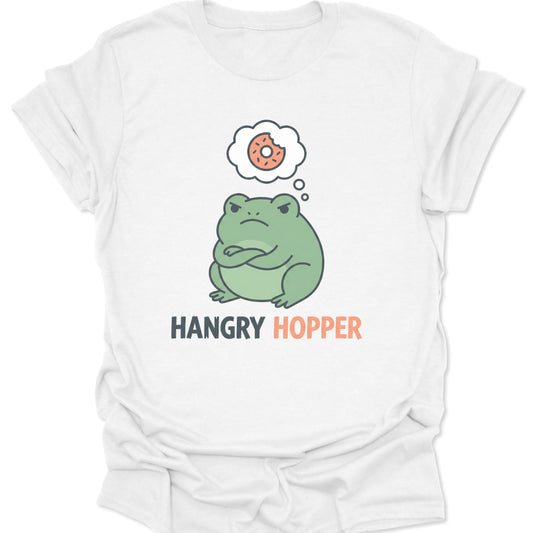 White unisex adult t-shirt featuring a grumpy green frog with crossed arms thinking about a pink frosted donut.
