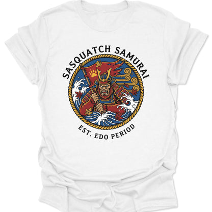 White unisex adult t-shirt featuring a Sasquatch Samurai in red armor with blue waves and Japanese tattoo art elements.