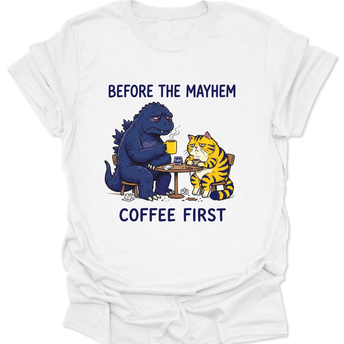 White unisex adult t-shirt showing a grumpy kaiju and tabby cat having a morning brew funny graphic design.