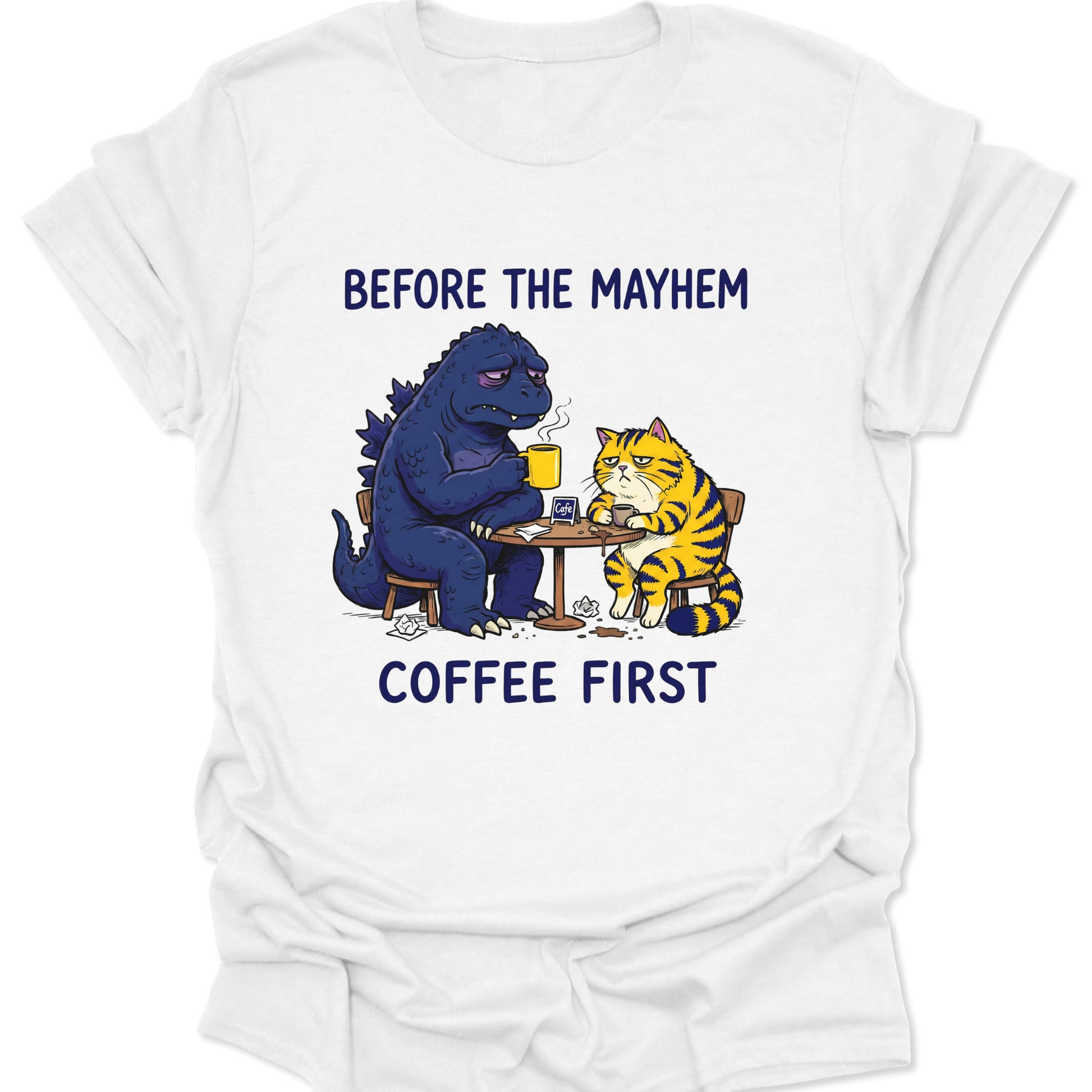 White unisex adult t-shirt showing a grumpy kaiju and tabby cat having a morning brew funny graphic design.