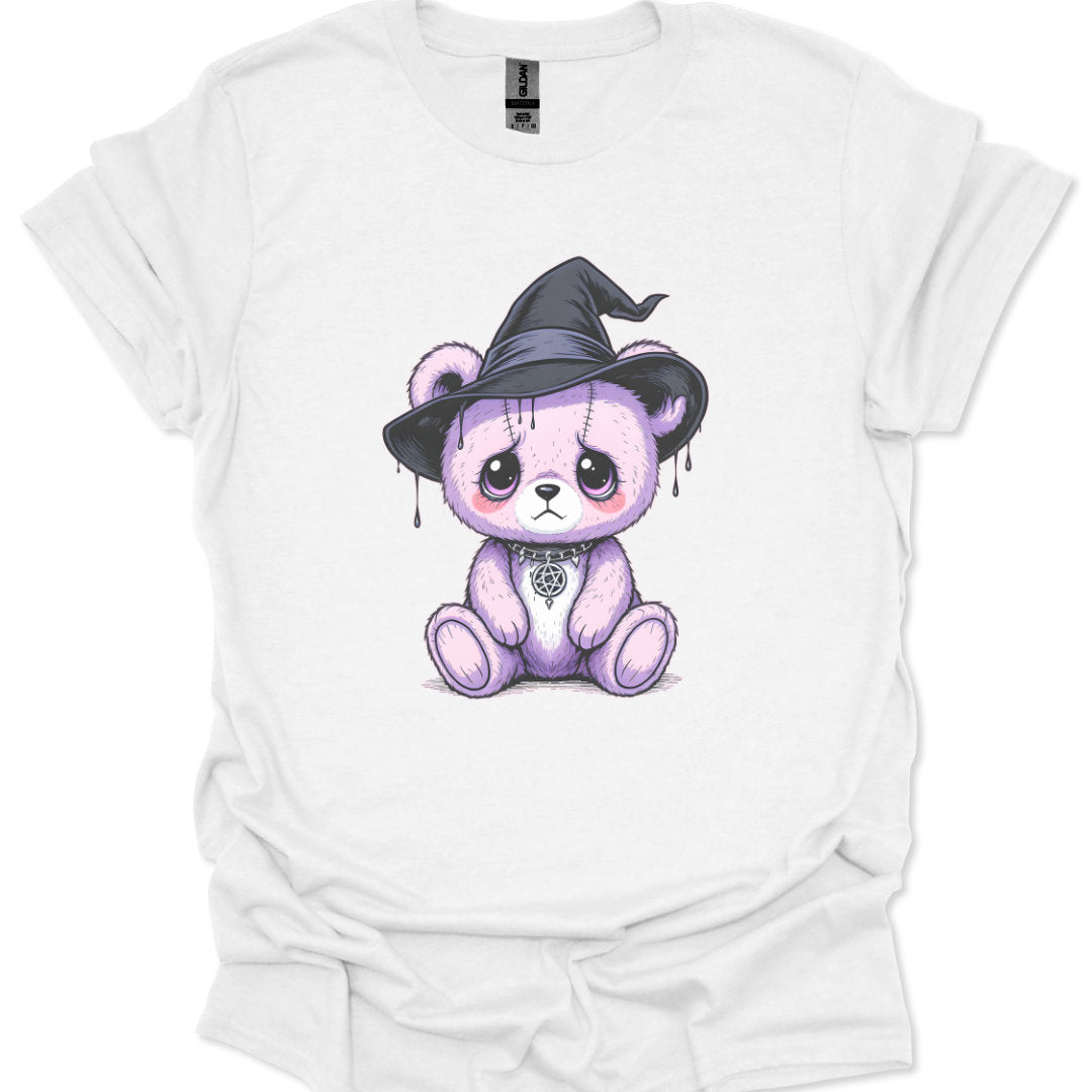 White t-shirt with a purple bear wearing a witch hat graphic design.