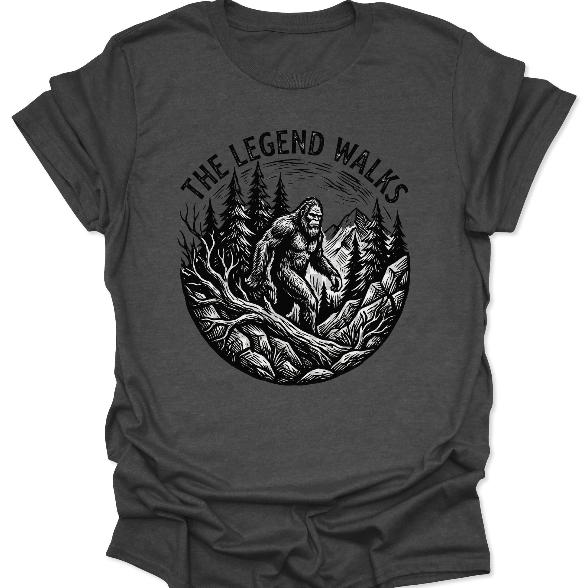 Dark Heather unisex adult t-shirt featuring a detailed Bigfoot silhouette emerging from a vintage-style circular nature scene.