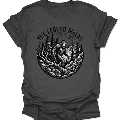 Dark Heather unisex adult t-shirt featuring a detailed Bigfoot silhouette emerging from a vintage-style circular nature scene.