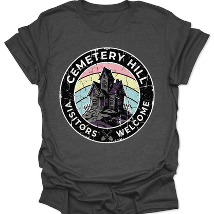 Dark Heather unisex adult t-shirt showing a retro spooky souvenir design with a purple mansion and rainbow sky.