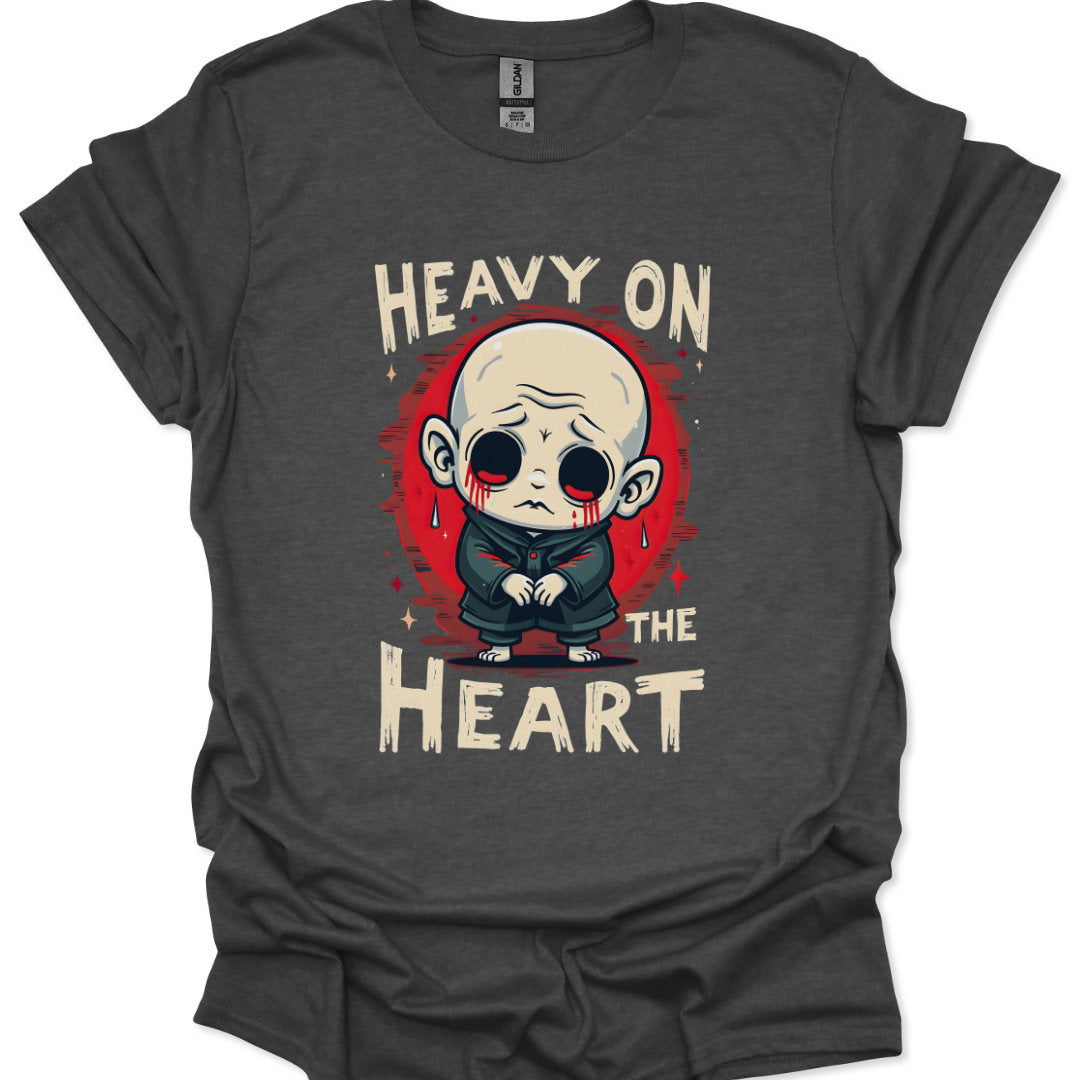 Gray t-shirt with a graphic design of a character and text 'Heavy on the Heart' on a white background
