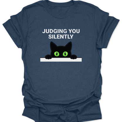 Heather Navy unisex adult t-shirt featuring a peeking black cat with green eyes and Judging You Silently text.