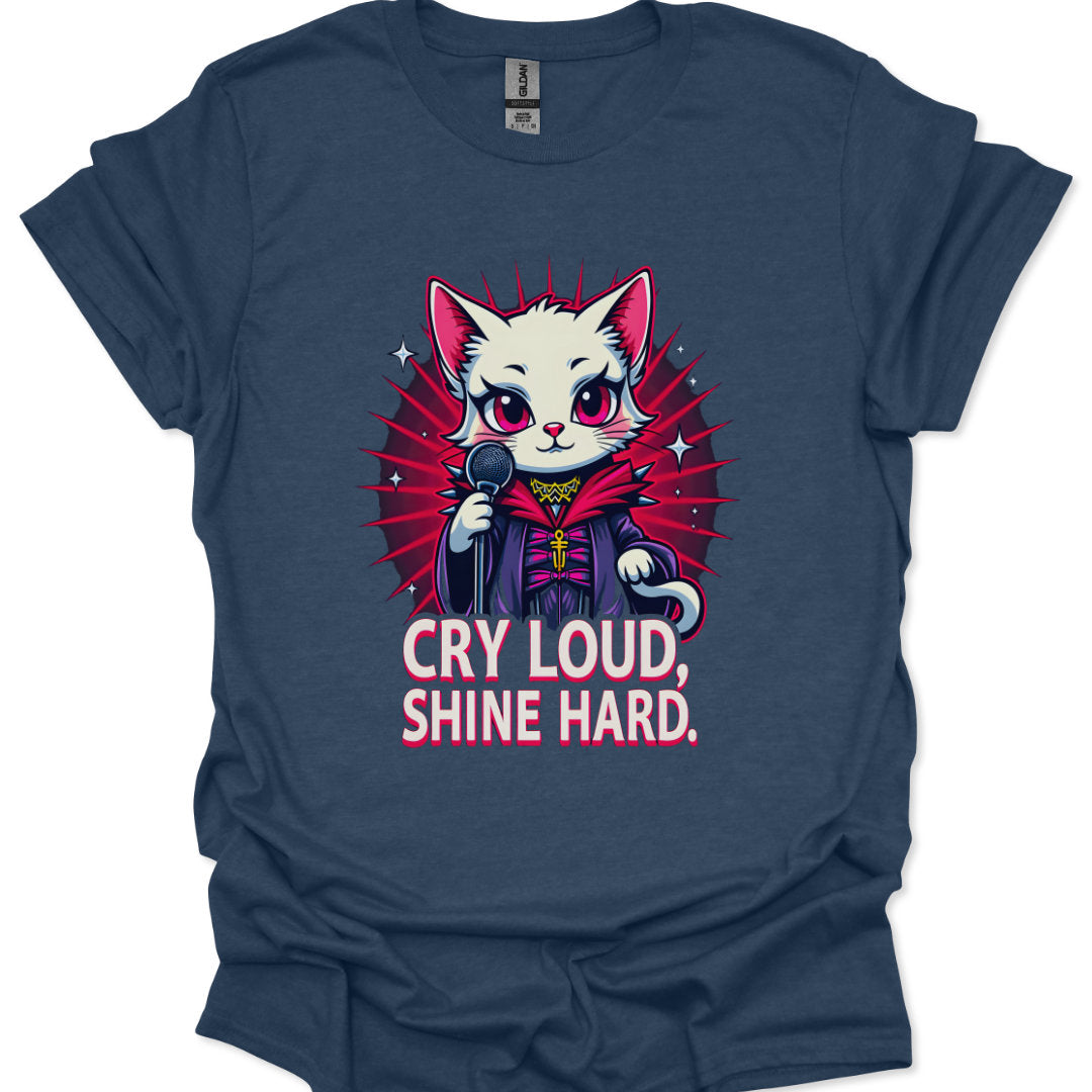 Navy blue t-shirt with a graphic of a cat in a robe and microphone, and text 'Cry Loud, Shine Hard' on a white background.