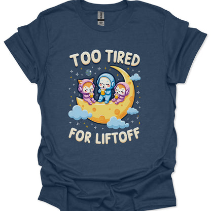 Navy blue t-shirt with cartoon characters on a moon and 'Too Tired for Liftoff' text.