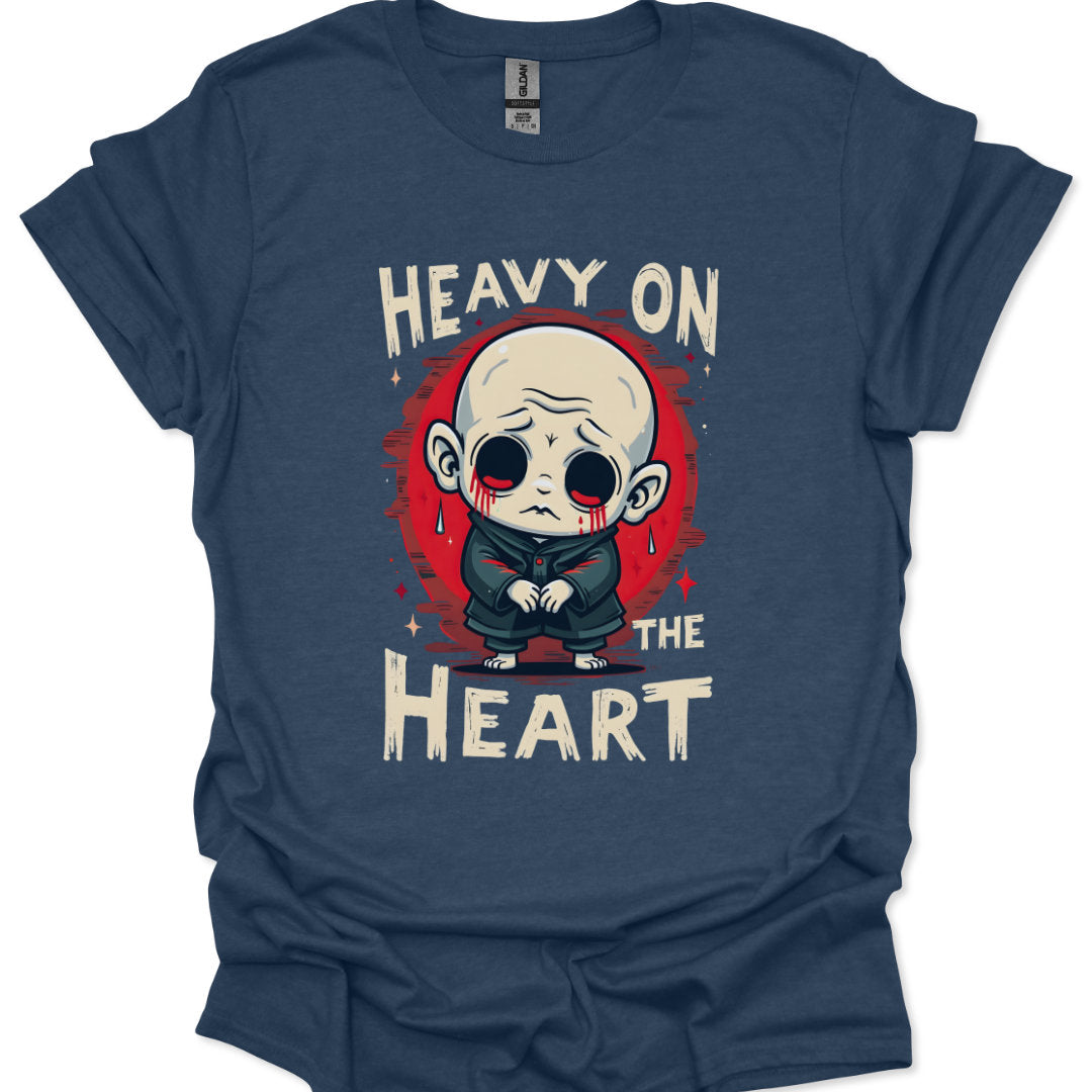 Navy blue t-shirt with a graphic design of a character and text 'Heavy on the Heart' on a white background.