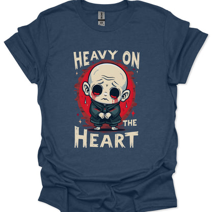 Navy blue t-shirt with a graphic design of a character and text 'Heavy on the Heart' on a white background.