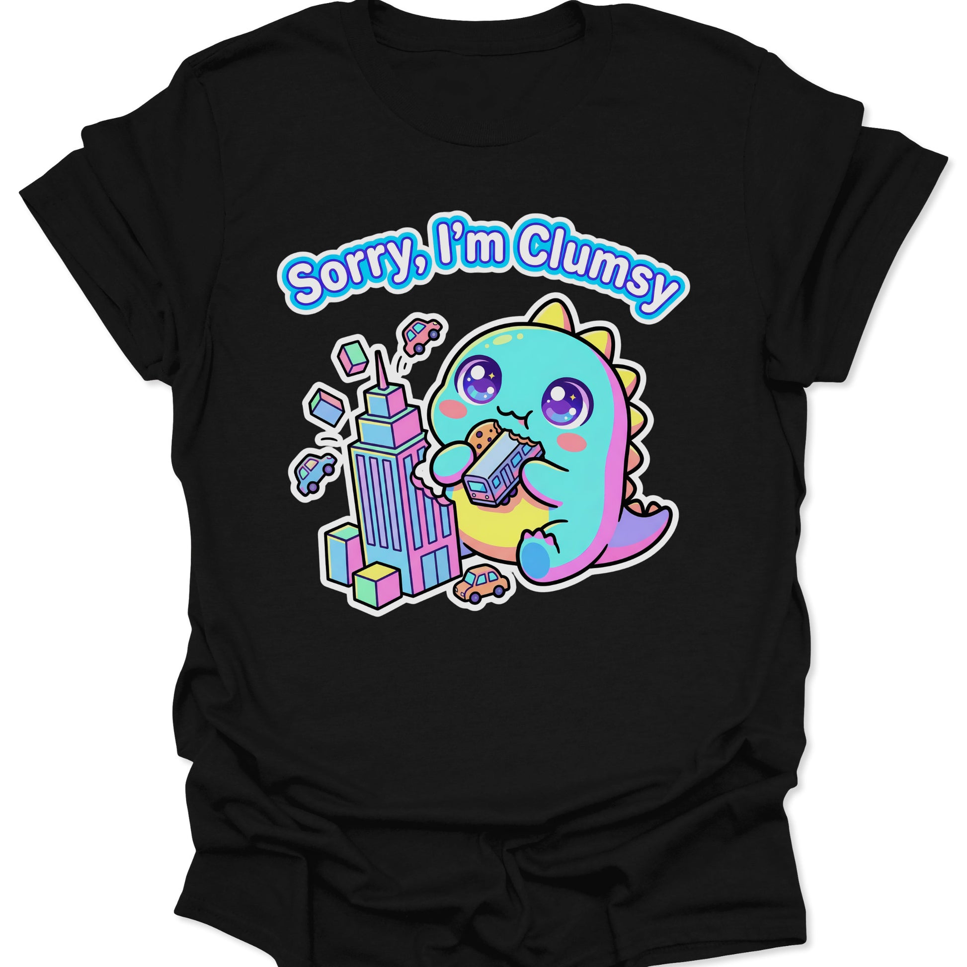Black unisex adult t-shirt featuring a pastel chibi kaiju eating a bus with "Sorry, I'm Clumsy" text in bubbly letters.