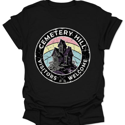 Black unisex adult t-shirt featuring a distressed pastel goth haunted house badge and Cemetery Hill text.