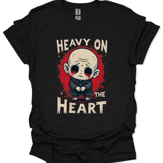 Black t-shirt with a graphic design of a character and text 'Heavy on the Heart' on a white background.