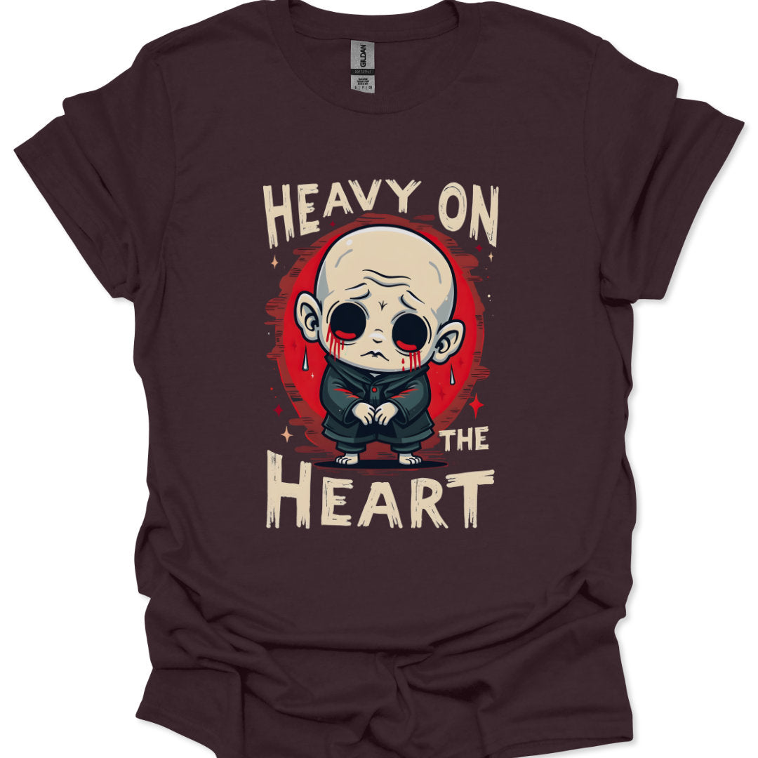 Brown t-shirt with a graphic design of a character and text 'Heavy on the Heart' on a white background