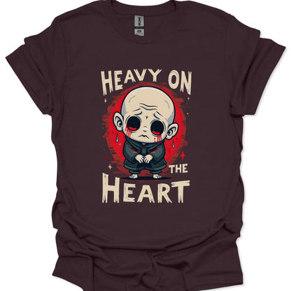 Brown t-shirt with a graphic design of a character and text 'Heavy on the Heart' on a white background