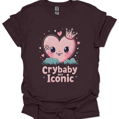 Brown t-shirt with a heart graphic and text 'Crybaby but Iconic' on a white background
