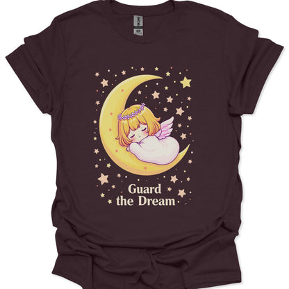 T-shirt with an angelic design on a crescent moon and stars, with text 'Guard the Dream' on a white background.