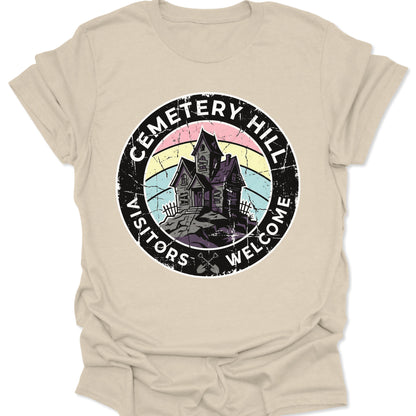 Natural unisex adult t-shirt displaying a vintage horror graphic with crossed shovels and Cemetery Hill typography.
