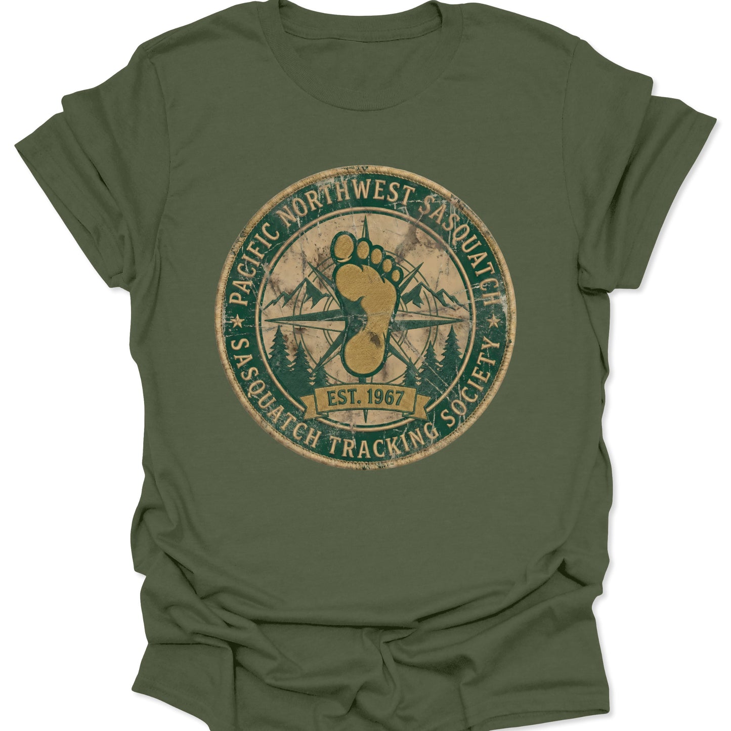 Military green unisex adult t-shirt featuring a circular Sasquatch Tracking Society emblem with forest green and gold earth tones.