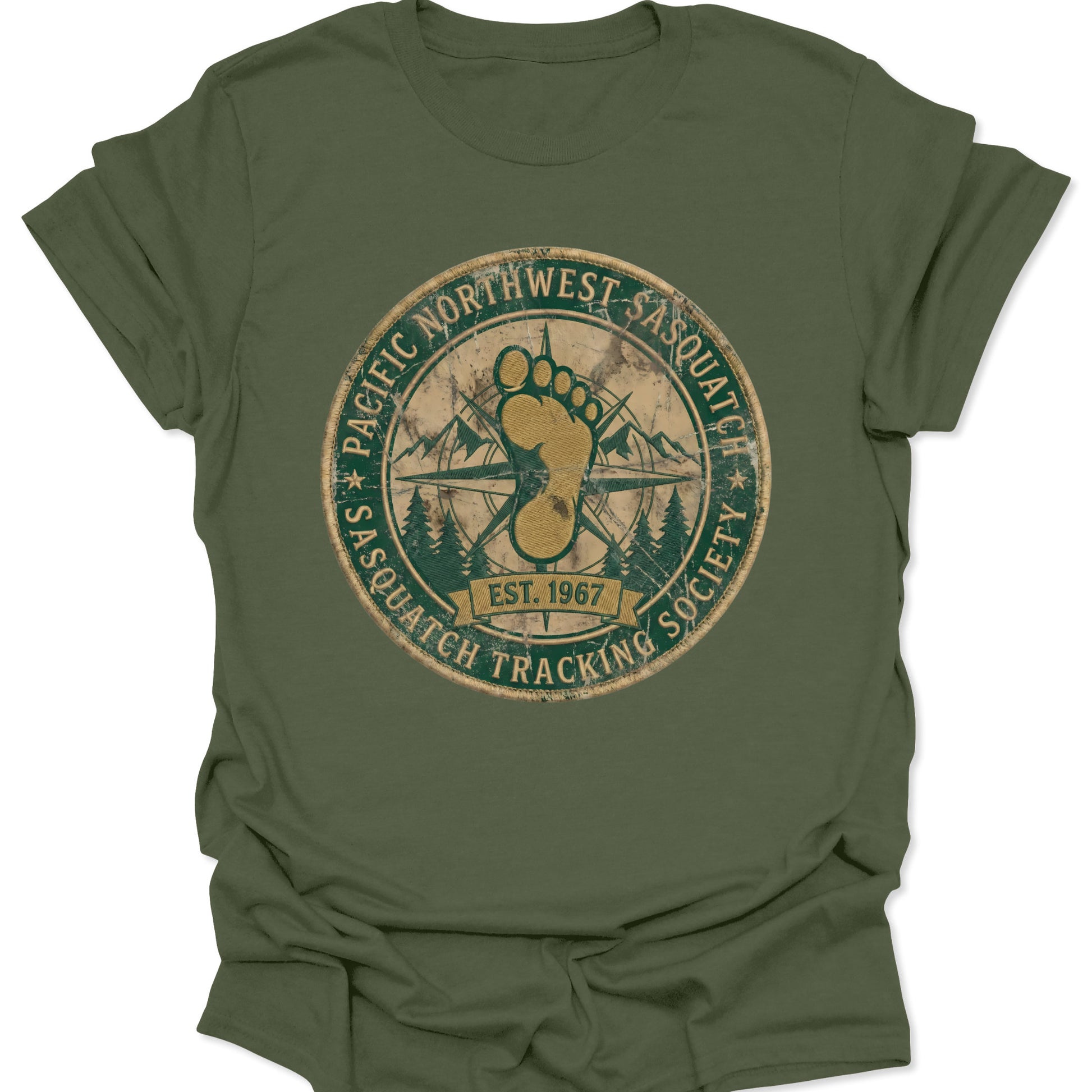 Military green unisex adult t-shirt featuring a circular Sasquatch Tracking Society emblem with forest green and gold earth tones.