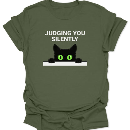 Military Green unisex adult t-shirt featuring a peeking black cat with green eyes and Judging You Silently text.