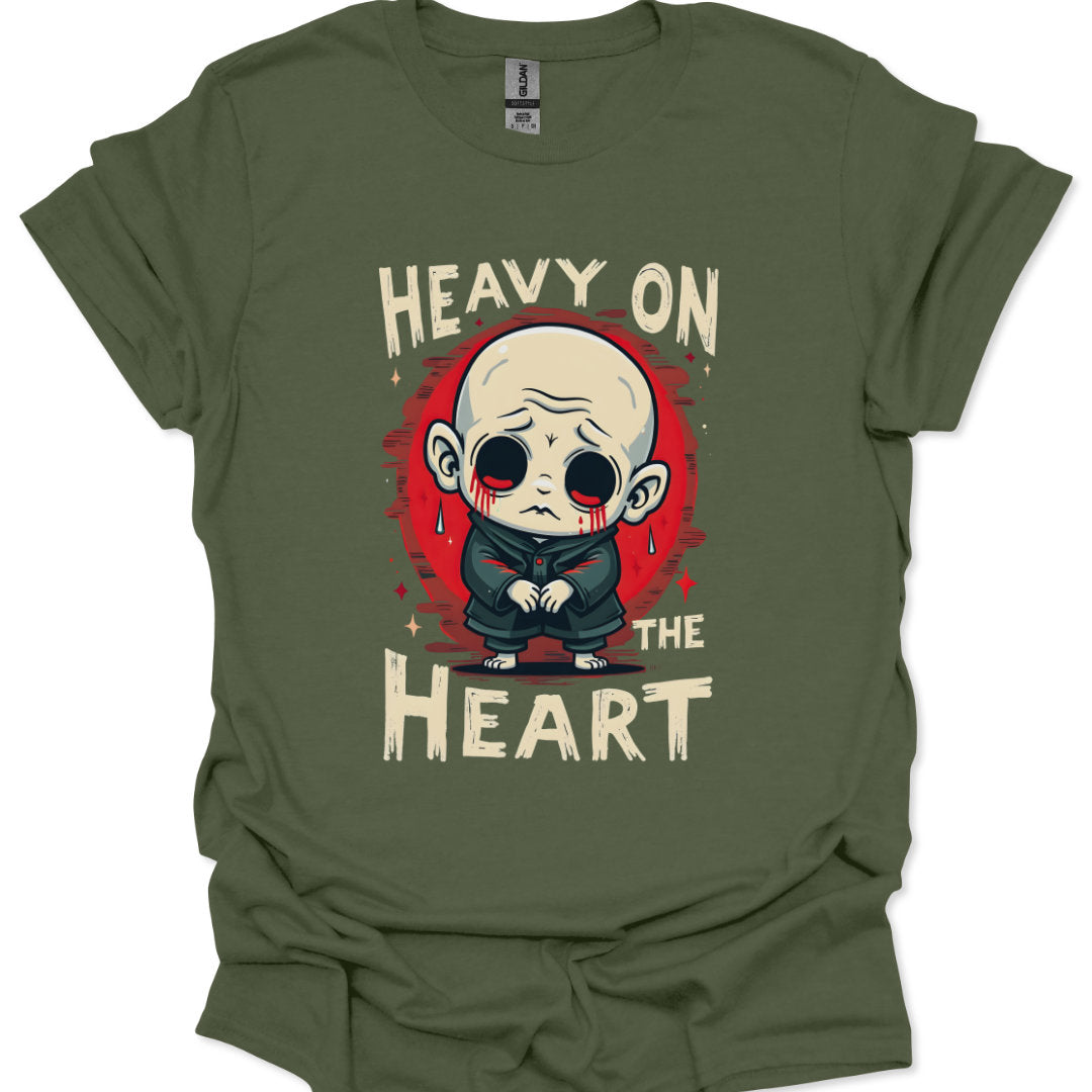 Green t-shirt with a graphic design of a character and text 'Heavy on the Heart' on a white background