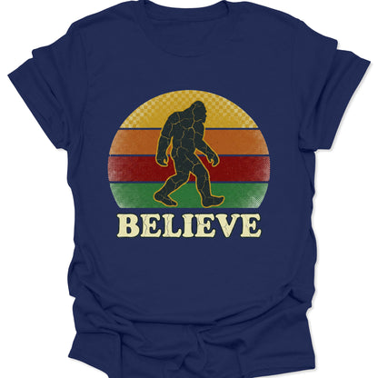 Navy unisex adult t-shirt with a vintage sunset Sasquatch graphic, perfect for urban legend and cryptid fans.
