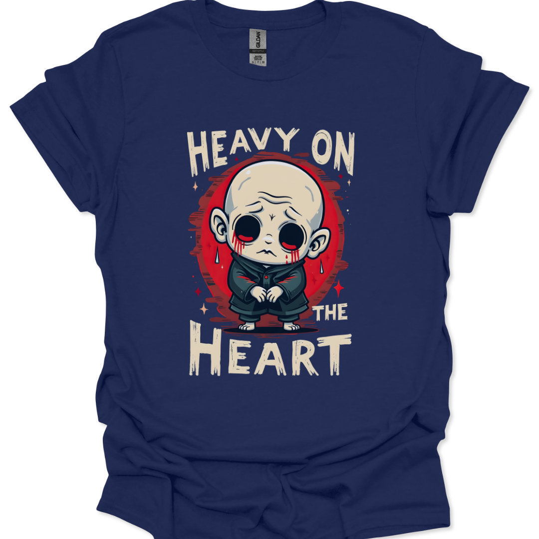 Navy blue t-shirt with a graphic design of a character and text 'Heavy on the Heart' on a white background.